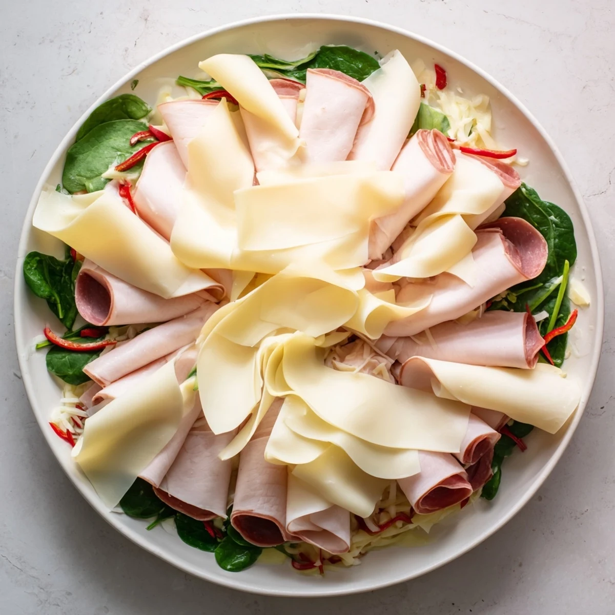 Sliced turkey and provolone pinwheels on a plate, ready to enjoy as a flavorful, easy appetizer.