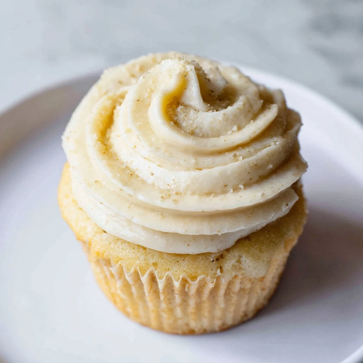 Fluffy vanilla cupcakes with generous buttercream frosting, ready to be enjoyed as a sweet treat.