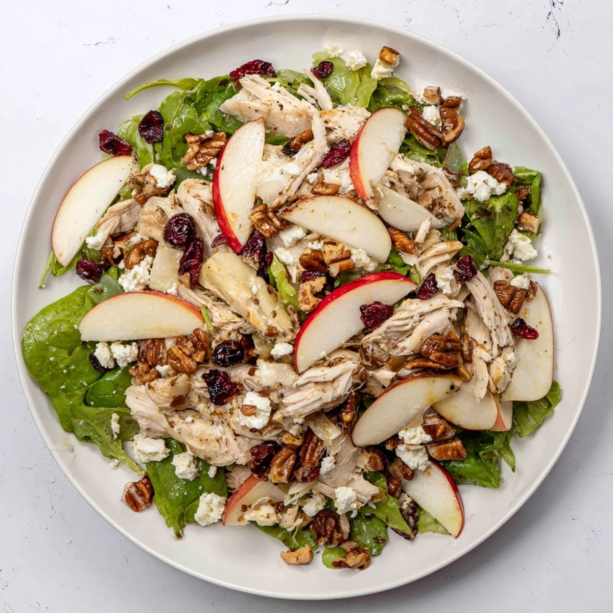 Chicken and Apple Winter Salad: A close-up of the fresh salad with glistening apple cider dressing.