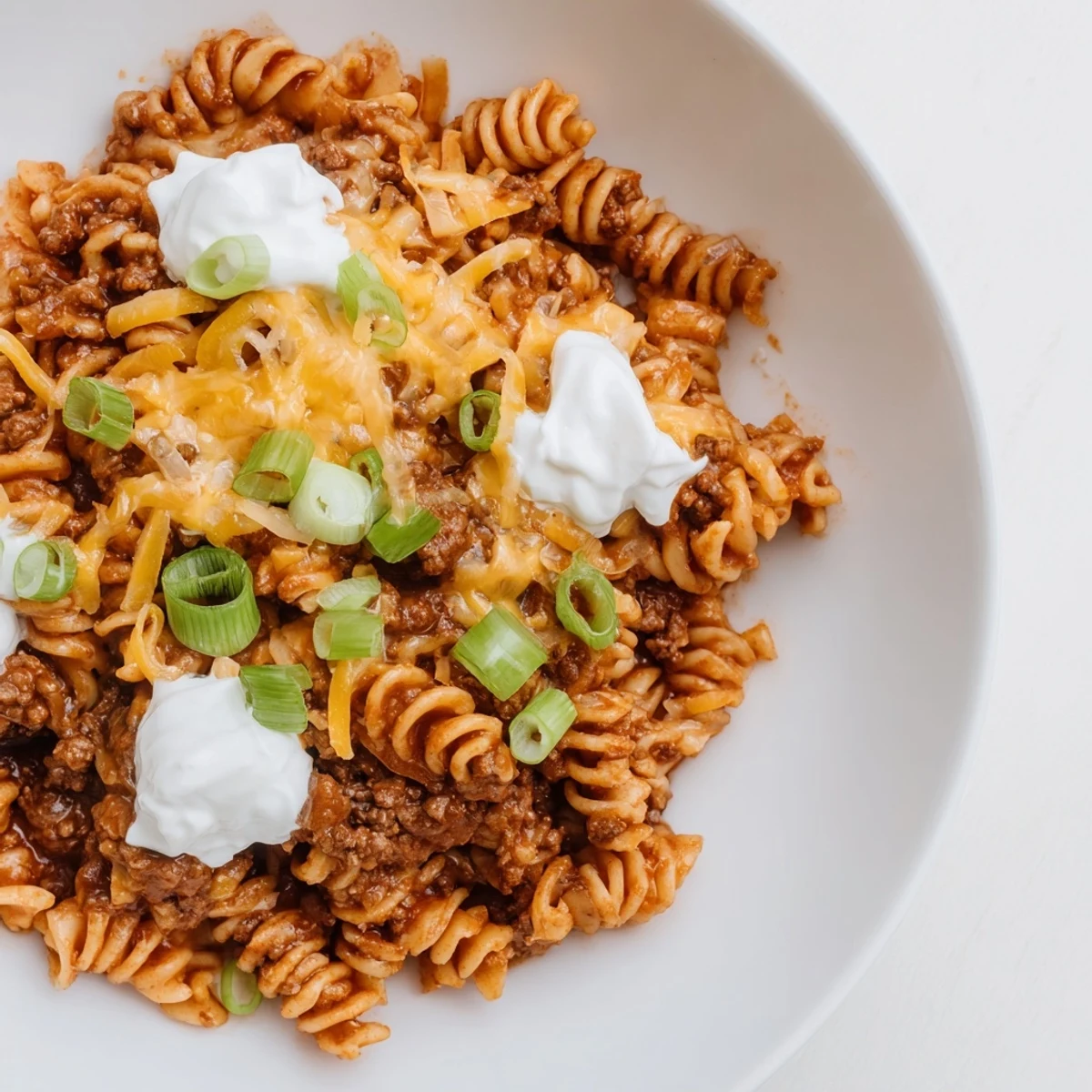 A comforting close-up showcases melted cheese atop savory one-pot taco pasta, ready to be enjoyed.