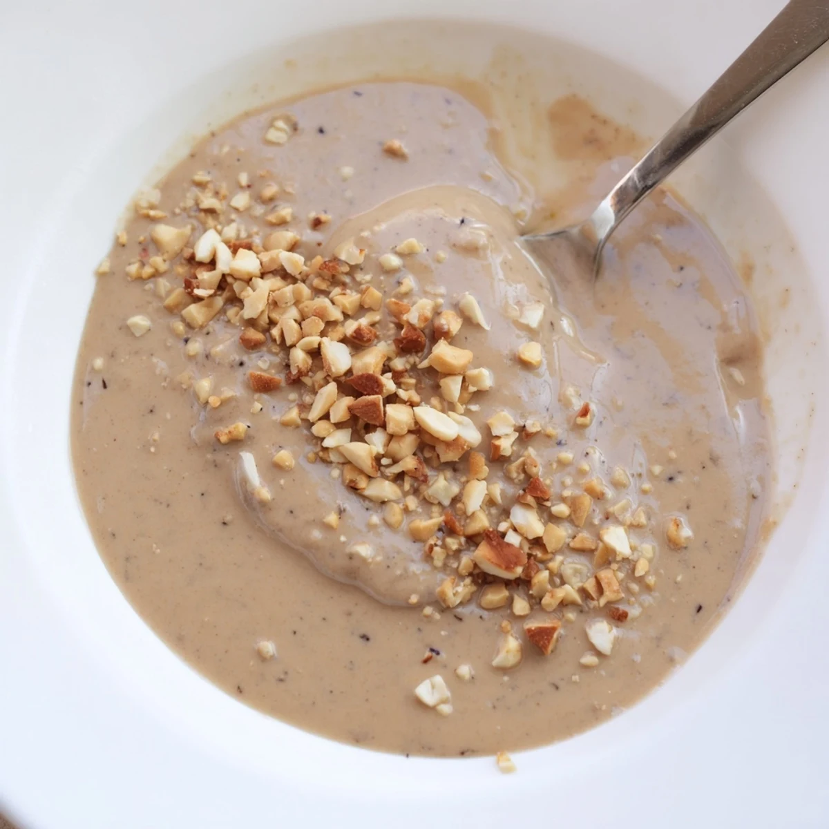 An appetizing shot of creamy Indonesian satay sauce, perfectly spiced and ready to drizzle.