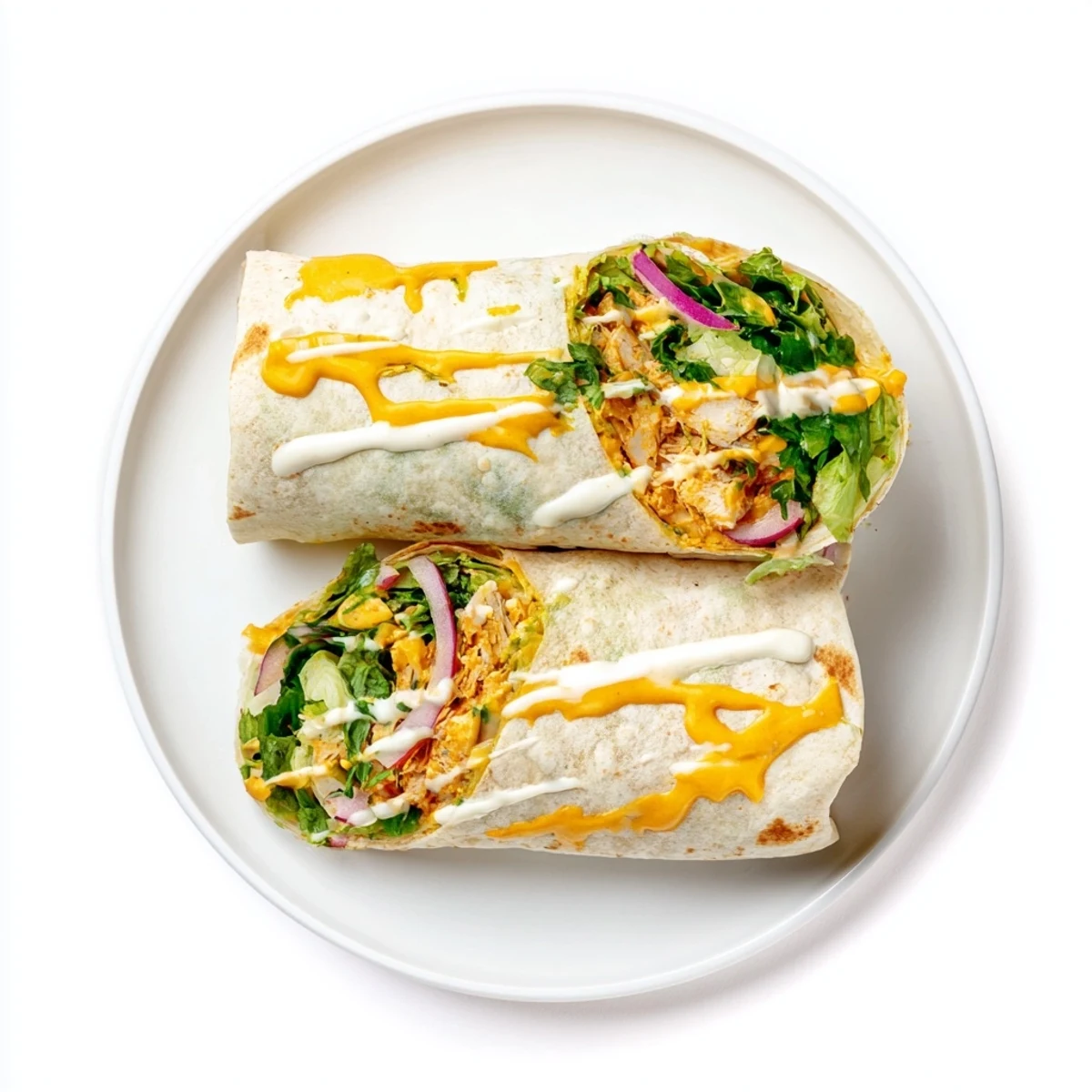 Plated Buffalo Ranch Chicken Wrap halves with celery sticks and a side of extra ranch dressing, perfect for a quick and satisfying lunch.