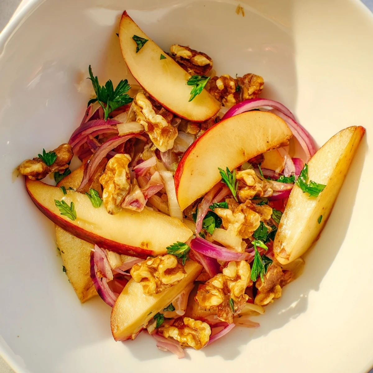 Warm Apple and Sauerkraut Skillet Salad with caramelized apples, red onion, and toasted pecans on a rustic wooden platter.  