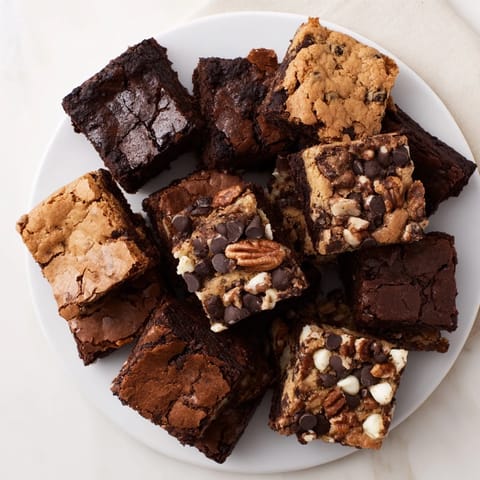 Close-up of baked dessert platter featuring rich, fudgy brownie and buttery blondie squares.