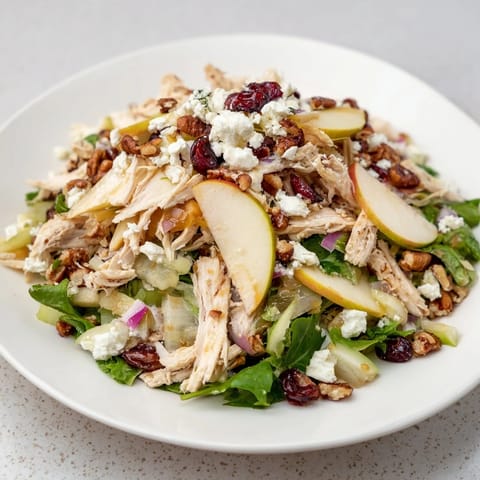 Vibrant Chicken and Apple Winter Salad, featuring juicy apples, tender chicken, and crunchy pecans.
