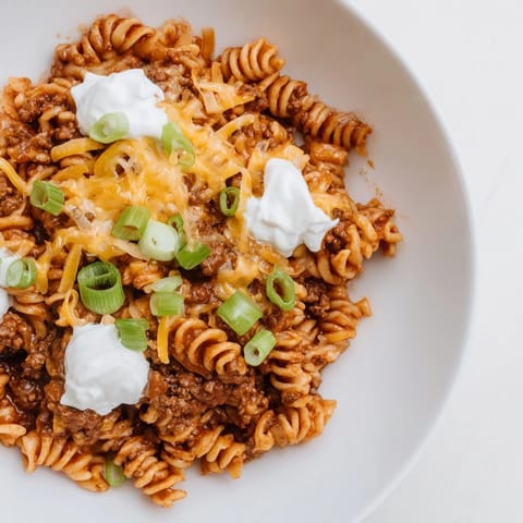 A comforting close-up showcases melted cheese atop savory one-pot taco pasta, ready to be enjoyed.