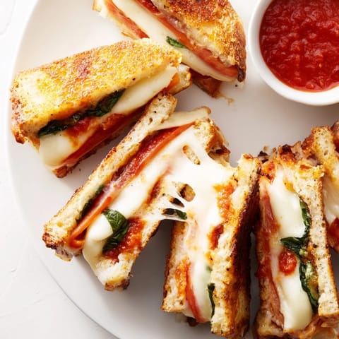 Fresh basil and ripe tomato slices add bright flavor to these easy, vegetarian Italian-American grilled cheese dippers served warm from the skillet.