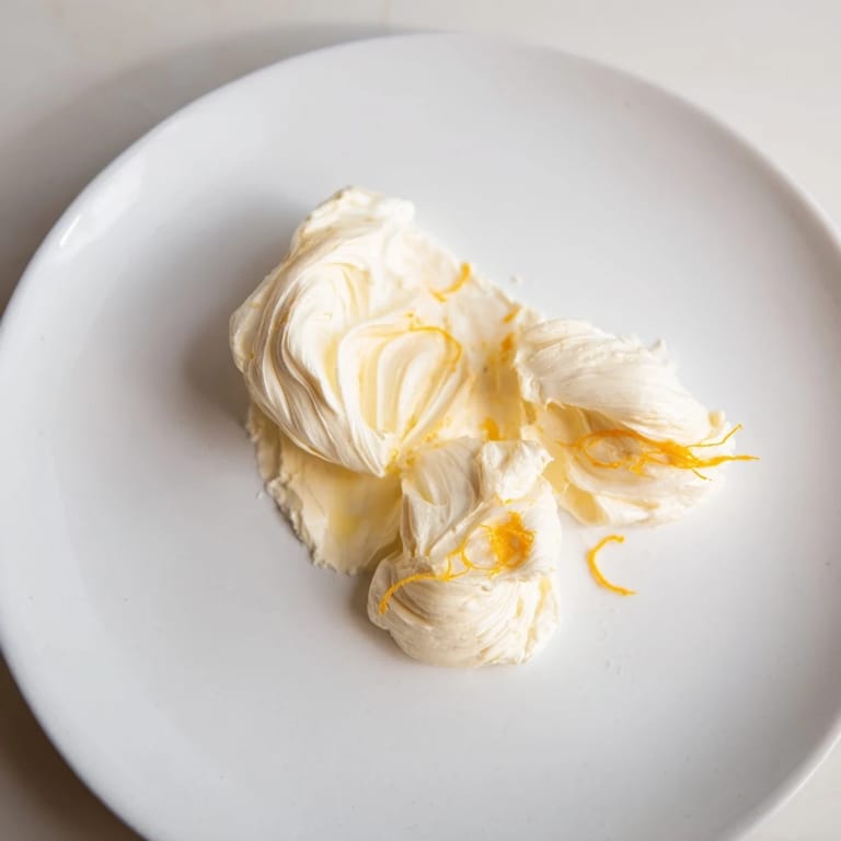 This Saffron Silk cheese board showcases creamy mascarpone and ribboned cheeses; a perfect appetizer ready for guests.