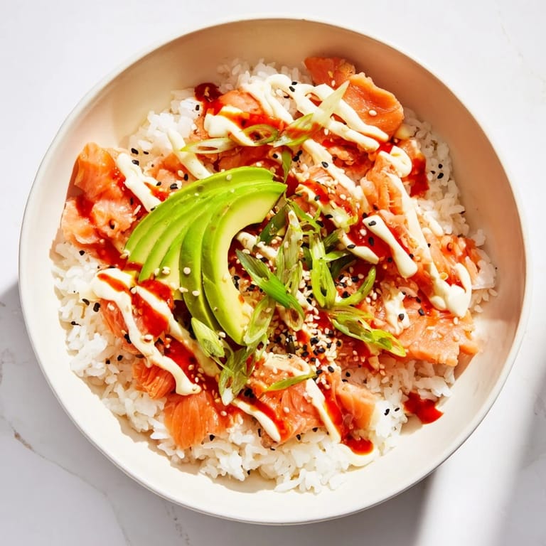 Fluffy white rice topped with seasoned, flaked salmon creating a beautiful Classic Salmon Rice bowl.