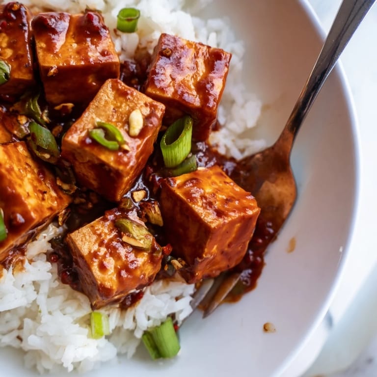 Savory Chinese Mapo Tofu, featuring the tenderest tofu in a spicy, flavorful, and aromatic sauce.