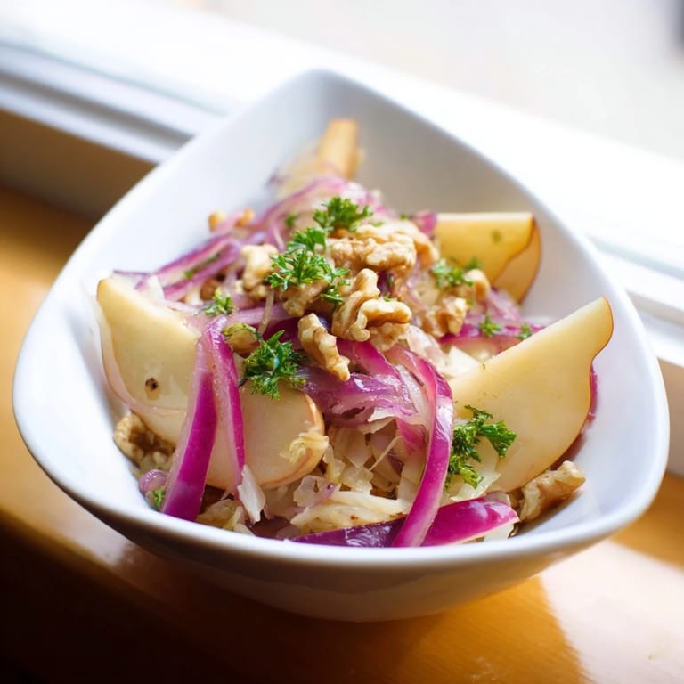 Vibrant vegetarian Warm Apple and Sauerkraut Skillet Salad, a tangy side dish with golden apples and caraway seeds.
